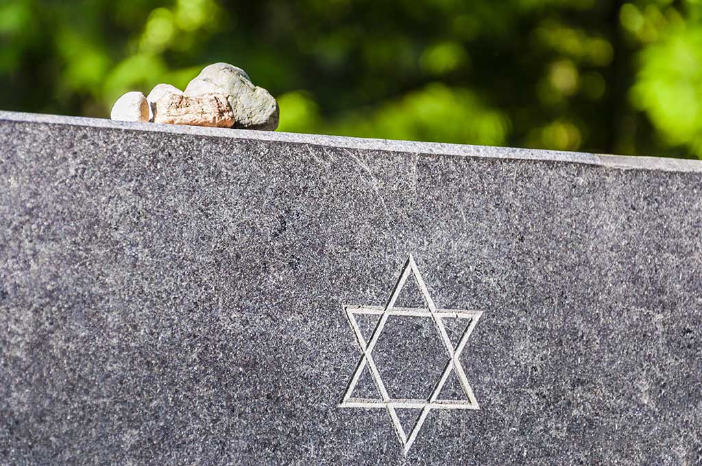 Stones on Jewish Memorial granite plate with Star of David